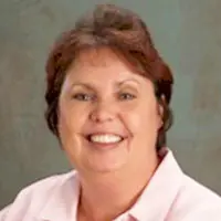 Headshot of a redheaded businesswoman smiling