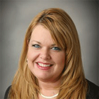 Headshot of a blonde businesswoman smiling