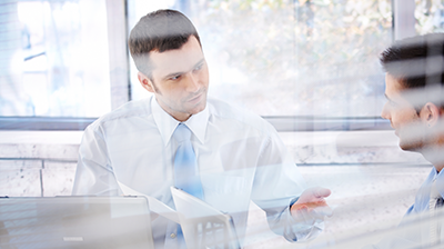 A businessman posing a question to a colleague